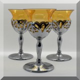 G65. Set of 3 yellow glass wine goblets with silver tone stems and overlay. 6.5”h - $18 